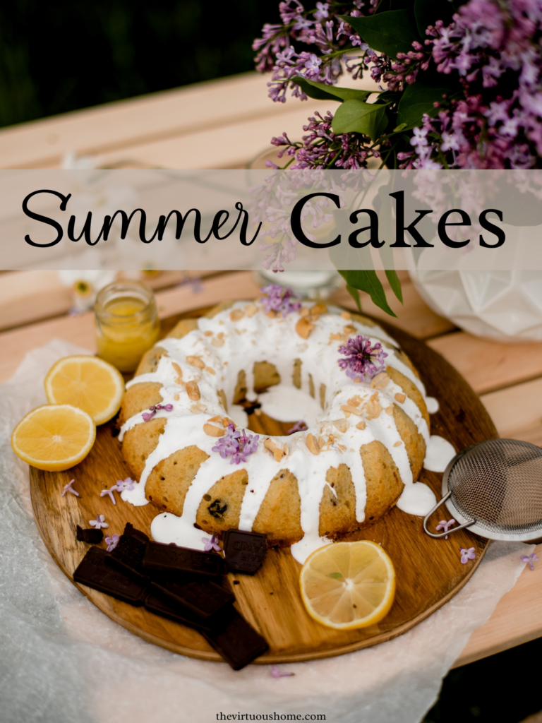 Berry Bundt Cake with icing, lemons, and a bouquet of purple flowers